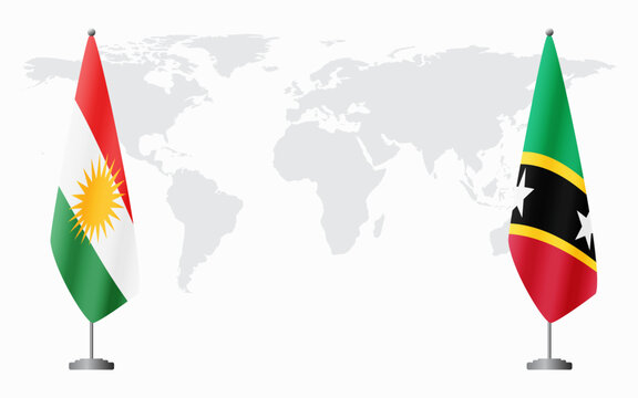 Kurdistan and Saint Kitts and Nevis flags for official meeting against background of world map.