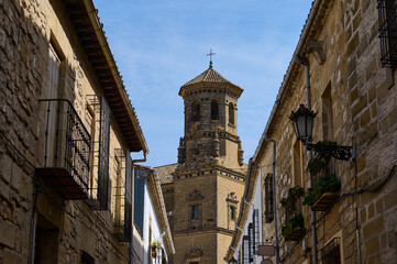 Fototapeta premium Historic stone buildings and tower against clear blue sky