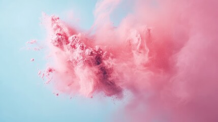 Obraz premium Colorful pink powder explosion in motion against a soft blue background creating a dynamic and vibrant abstract design element.