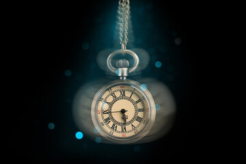 Hypnosis session. Vintage pocket watch swinging on black background, motion blur effect. Magic...