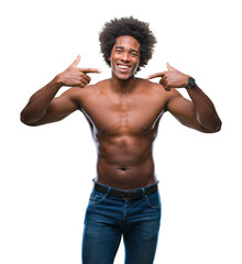 Fototapeta premium Afro american shirtless man showing nude body over isolated background smiling confident showing and pointing with fingers teeth and mouth. Health concept.