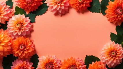 Orange and pink dahlia flowers, on a soft coral background with scattered green leaves for contrast. Background with a place to copy.