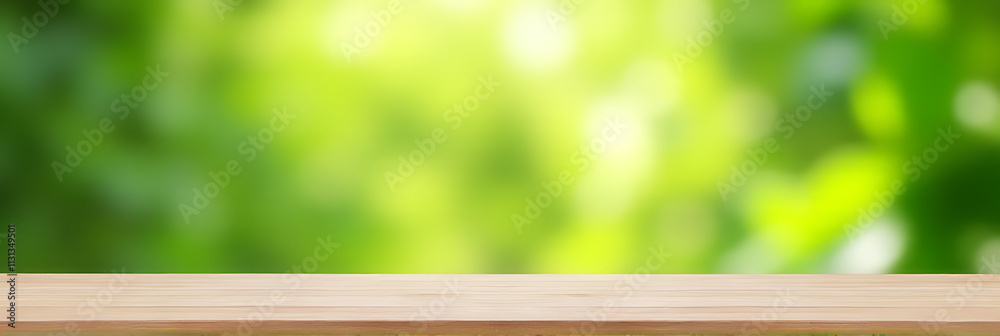 Aufkleber a blank wooden tabletop with a blurred green garden view in the background is ideal for product disp