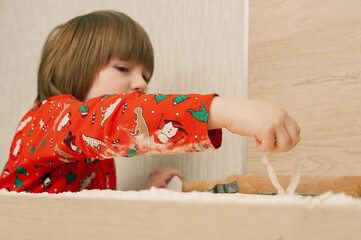 Caucasian boy crafing decorations or opening presents  at home candid shot candind shot winter holiday activities