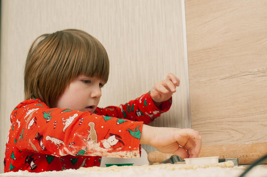Caucasian boy crafing decorations or opening presents  at home candid shot candind shot winter holiday activities