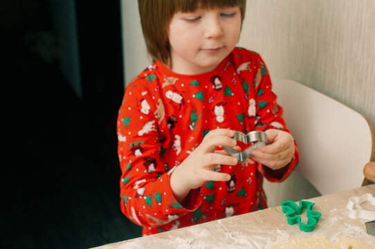 Caucasian boy crafing decorations or opening presents  at home candid shot candind shot winter holiday activities