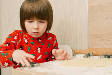 Caucasian boy crafing decorations or opening presents  at home candid shot candind shot winter holiday activities