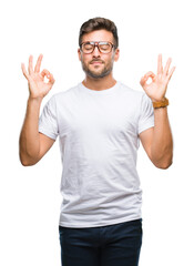 Young handsome man wearing glasses over isolated background relax and smiling with eyes closed doing meditation gesture with fingers. Yoga concept.