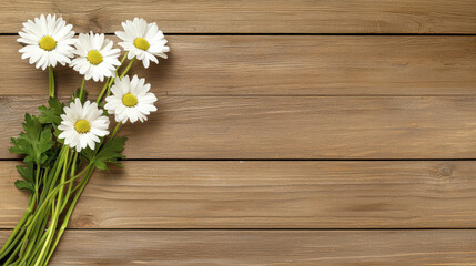 Fototapeta premium Fresh white daisies arranged on rustic wooden background create serene and natural atmosphere, perfect for spring decor or floral themes