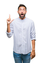 Naklejka premium Adult hispanic man over isolated background pointing finger up with successful idea. Exited and happy. Number one.