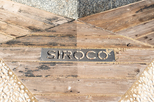 Wooden walkway with Siroco wind direction plaque in Tarifa, Spain