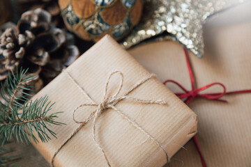 A close-up of Christmas gifts wrapped in elegant paper, surrounded by festive holiday decorations, in a retro style.