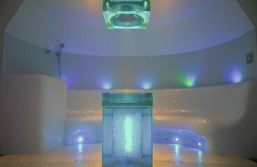 Turkish bath or steam sauna with mosaic tiles inside male locker room of spa or wellness are...