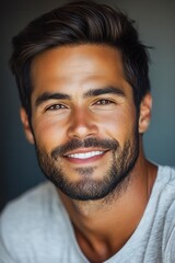 Obraz premium Portrait of a smiling man with a beard enjoying a casual moment indoors in a relaxed setting