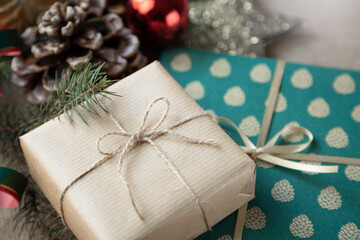 A close-up of Christmas gifts wrapped in elegant paper, surrounded by festive holiday decorations, in a retro style.