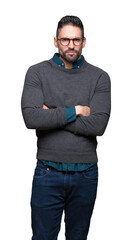 Young handsome man wearing glasses over isolated background skeptic and nervous, disapproving...