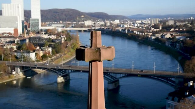 Basler M&uuml;nster roof with lightning rod against cityscape with Rhine river in background