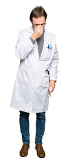 Fototapeta premium Middle age doctor men wearing medical coat tired rubbing nose and eyes feeling fatigue and headache. Stress and frustration concept.