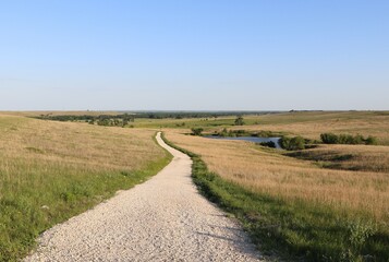 Hiking trail along prairie meadows in the Flint Hills of Southern, central Kansas. © Tammy Yeokum