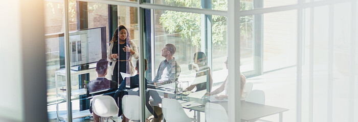 Woman, screen and presentation with group in boardroom, charts and review for stats at startup....