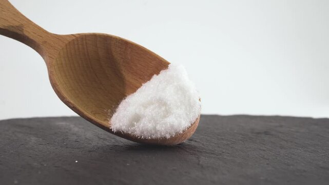 Close up of mono Monosodium glutamate (MSG)in spoon on white