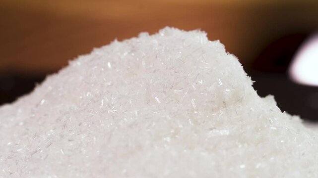 Close up of mono Monosodium glutamate (MSG)in spoon on white