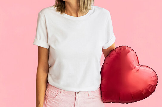 White t-shirt template ,pink red valentine&rsquo;s day decoration. Girl white t shirt mock up. Woman wearing white tshirt for your design. textille