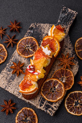 Delicious sweet eclair with chocolate filling, covered with cream