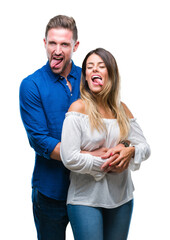 Fototapeta premium Young couple in love over isolated background sticking tongue out happy with funny expression. Emotion concept.