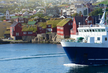 Traditional Faroese House with Grass Roofs and Ferry