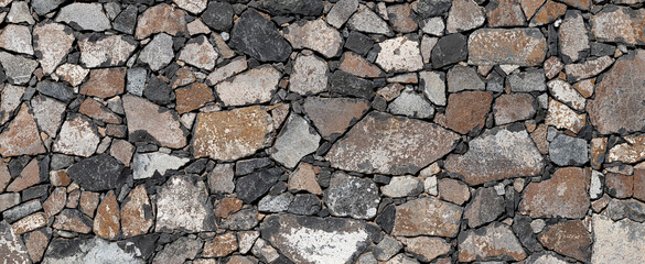 Obraz premium Panoramic natural texture with volcanic stones in gray and brown tones