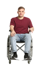 Young man in wheelchair on white background