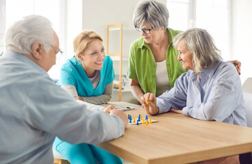 Obraz premium Retirement home activity with skilled nurse, nursing care and service for seniors, happy old people enjoy good time, elder patients under supervising and gerontological guiding, playing game fun