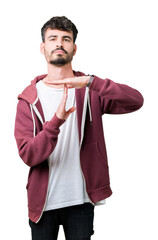 Young handsome man over isolated background Doing time out gesture with hands, frustrated and...