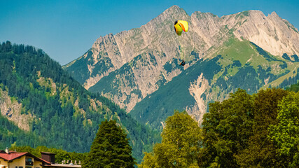 Alpine summer view with a paraglider in flight and the Karwendel mountains at Pertisau, Lake...