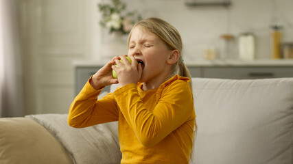 Little girl home biting eat apple food nutrition grabbing tooth pain dental disease hurt toothache...