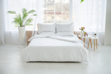 Bedroom with a large bed and flowers.