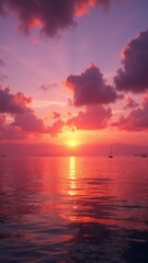 Obraz premium Stunning sunset at sea with vibrant colors and sailboats on the horizon
