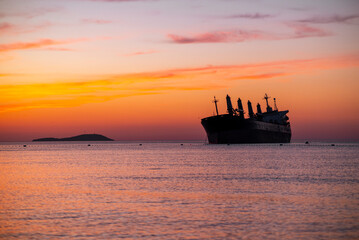 Sunset View of Cargo Ship at Sea