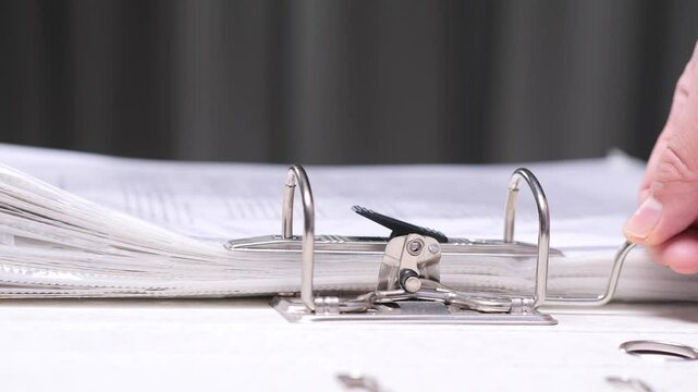 close-up Office worker placing documents binder folder in lever arch file