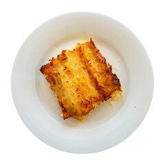 Traditional Italian rolls with minced meat on a white plate. Delicious pasta dish Canelone de carne. Isolated over white background