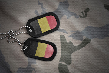 army blank, dog tag with national flag of belgium on the khaki texture background. military concept