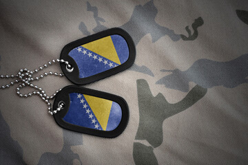 army blank, dog tag with national flag of bosnia and herzegovina on the khaki texture background....