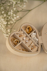 Jewelry in a case. Give a piece of jewelry.