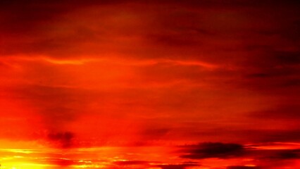 Obraz premium Abstract dark red and yellow sky background with burning sky effect, and rays of sunlight during sunset. Topics: hot colors, cloudy background, weather, meteorology, climate, air space, atmosphere