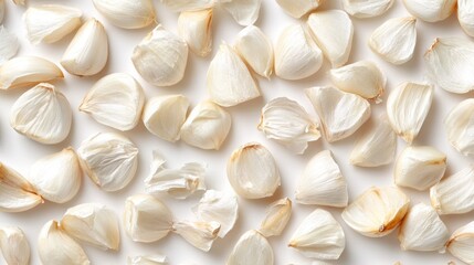 A close-up view of garlic cloves scattered on a surface.