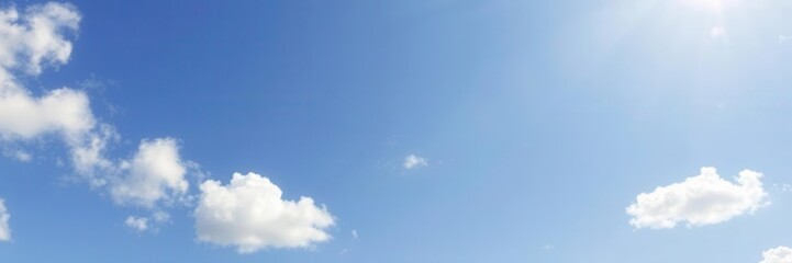 Fototapeta premium Bright blue sky with fluffy white clouds on a summer day, clear skies, sunny, blue