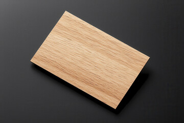 Naklejka premium Modern wooden business card design on dark background, showcasing minimalist aesthetic. natural texture of wood adds unique touch to professional branding