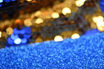 Golden and Blue Glitter Fusion: A Captivating Macro Shot of Sparkling Sequins and Glittery...