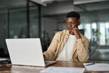 Busy professional African young company worker, male software developer typing on computer...
